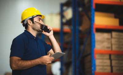 Logistiek medewerker praat in walkie-talkie